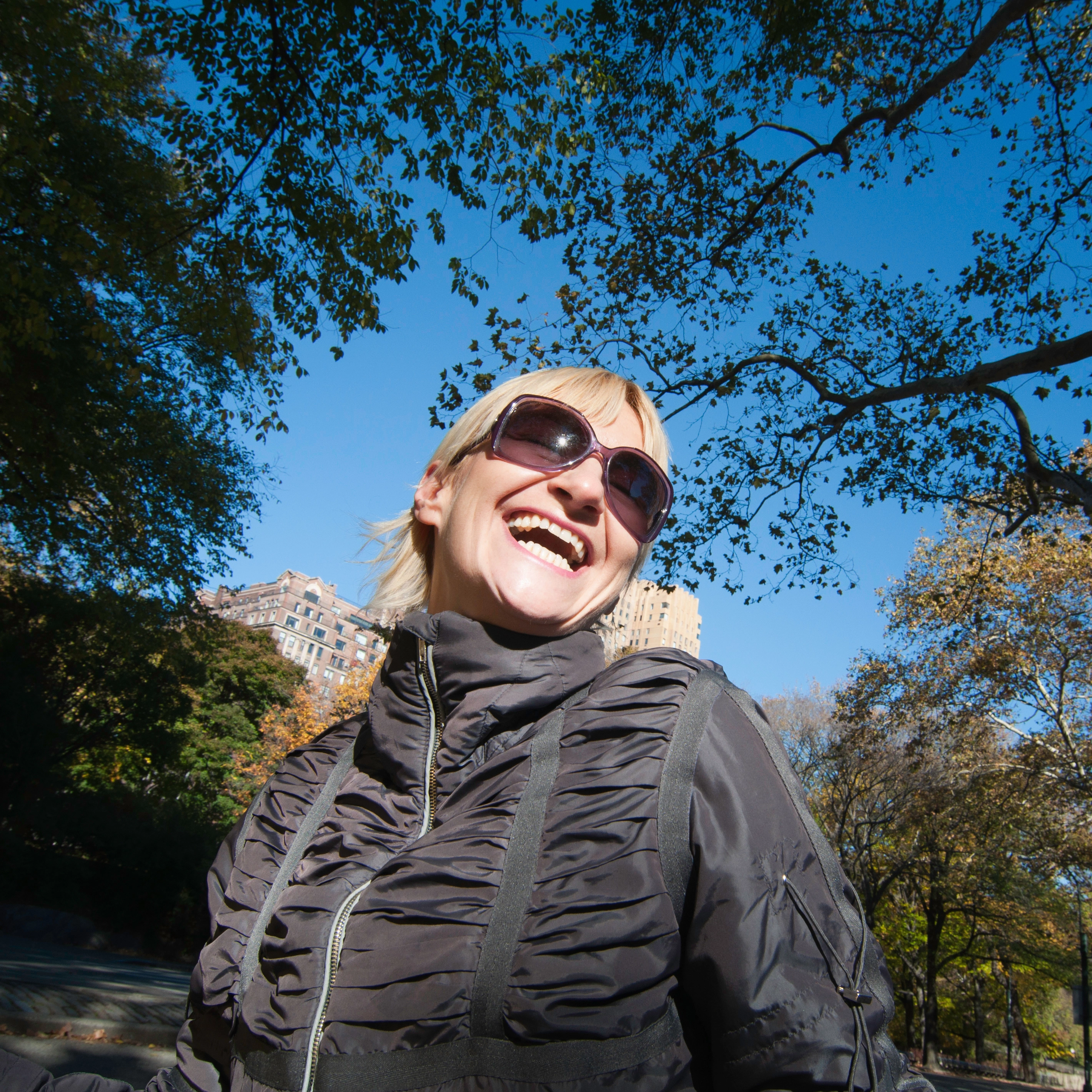 Smiling woman sunglasses outdoor park portrait Safe Demo Dallas