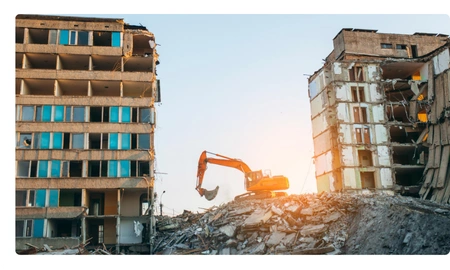 Large scale building demolition with excavator at sunset Safe Demo Dallas commercial demolition Dallas