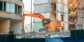 Excavator tearing down structure for redevelopment project Safe Demo Dallas demolition experts Dallas