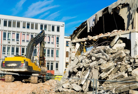 Safe Demo Dallas building demolition process using excavator for controlled structural removal
